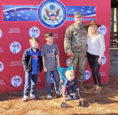 Woods students with family picture.